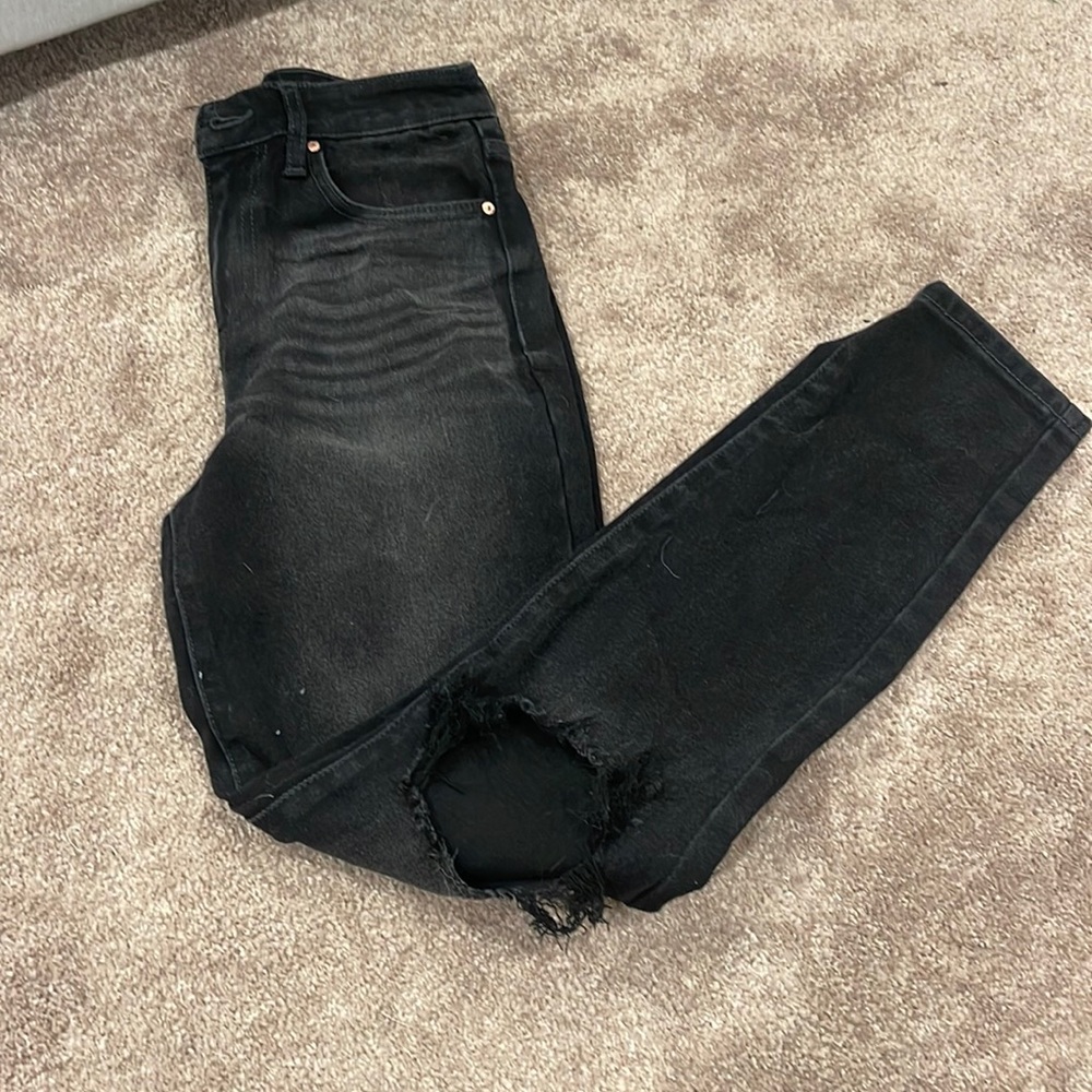 Women black ripped jeans with knee rips
